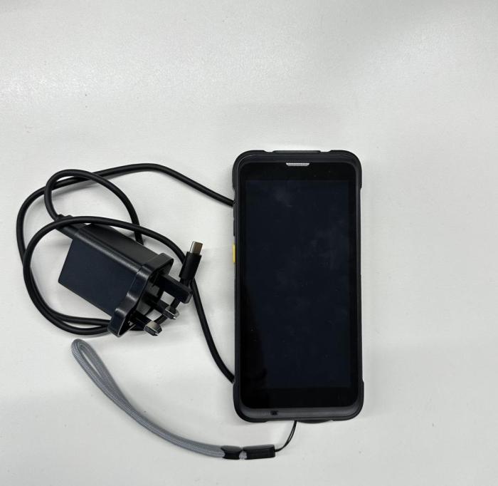 Photo of test device and charger, screen facing up.