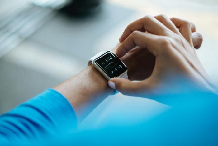 A person using a smartwatch on their wrist