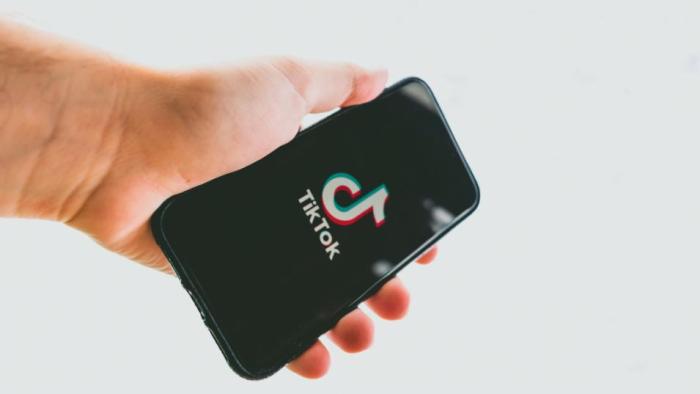 TikTok app on a phone in the hand of a person