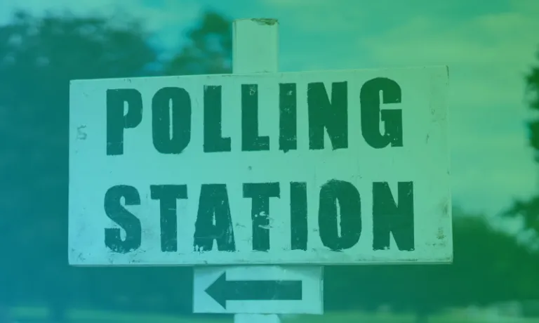 A black and white sign showing the words Polling Station and a left pointing arrow