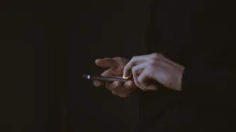 A person scrolling on a smart phone.