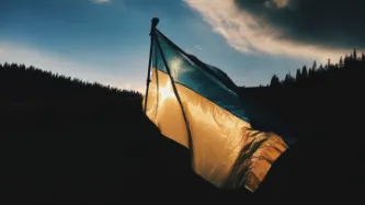 Ukrainian flag on mountain backdrop