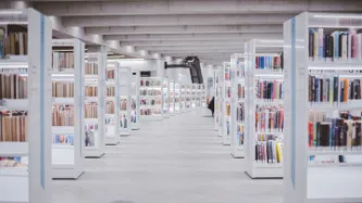 Library full of dozens of white bookshelves