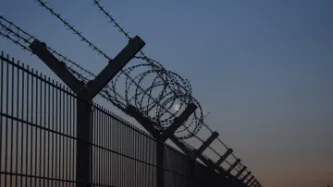 Photo of a border fence at night time