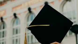 A graduation held aloft triumphantly