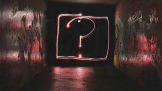 A light painting of a question mark in a dark corridor